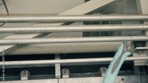 Industrial detail composed of pipes, hoses and valves. Indifferent background of metal materials, production of anhydrite concrete. Construction machinery industry. Daytime slowmotion shot