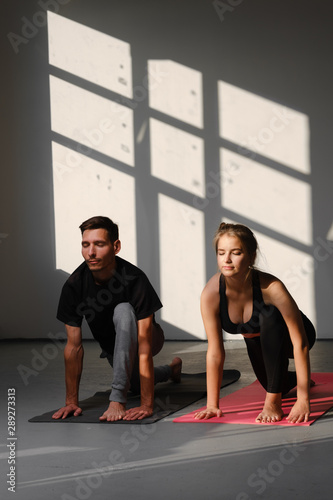Couple is doing yoga together. Healthy lifestyle concept.
