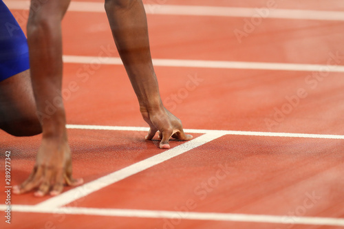 Close - up of the hands of the runner before the start