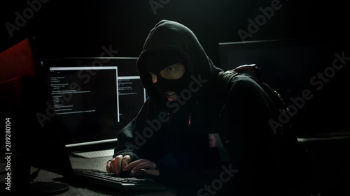 Hacker Robber Stealing Data on a Computer