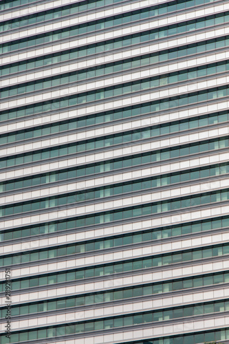 Glass windows and concrete walls in the daytime. Arcitectural fragment of modern building in Bangkok, Thailand.