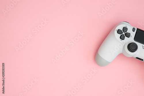 Video games white gaming controller isolated on pink color background top view