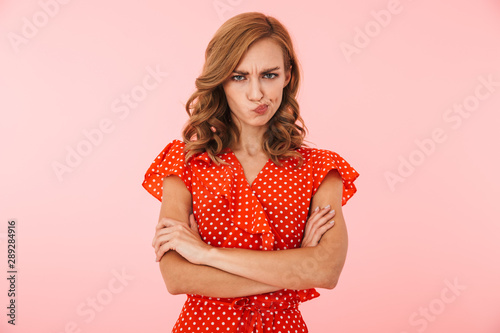 фотографія Displeased offended young woman posing isolated over pink wall background
