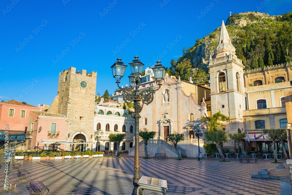 Square Piazza IX Aprile with San Giuseppe church and Clock Tower in Taormina, Sicily, Italy.
