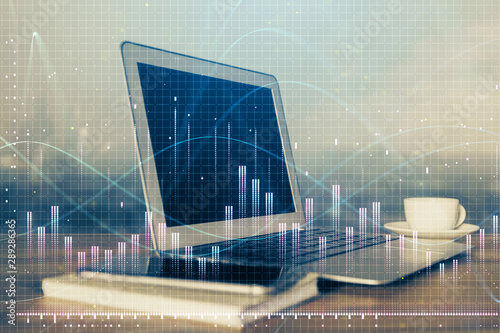 Financial chart drawing and table with computer on background. Multi exposure. Concept of international markets.