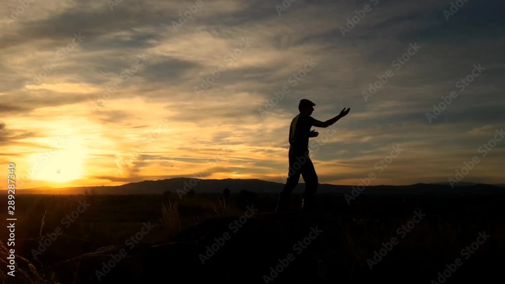 Silhouette of a man doing Tai Chi on a hilltop in Portugal. Silhouette of a man doing Tai Chi on a hilltop in Portugal.