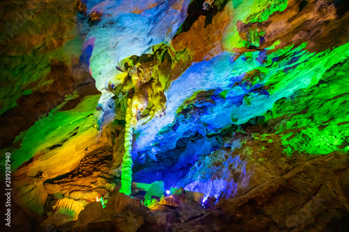 Beautiful illuminated multicolored stalactites in Danzhou Stone Flower Caves, Geopark next to Haikou, Hainan, China