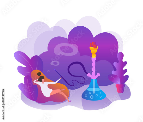 Young woman enjoy smoke a hookah relax sitting on a pillow