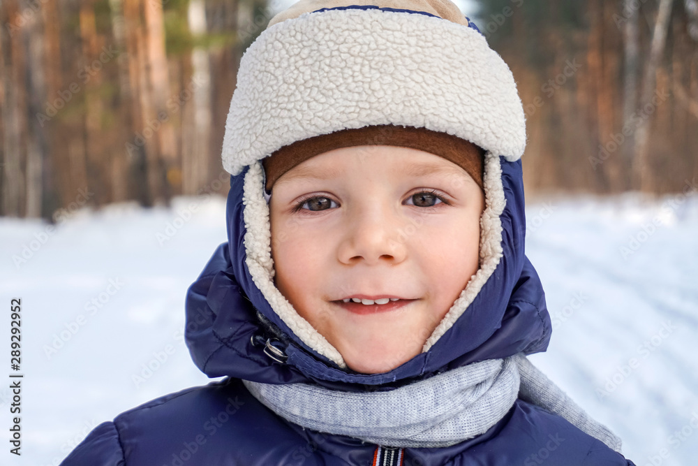 close up portrait of a happy child boy throws snow, snowflakes in the air in cold winter against the background of snowdrifts close up portrait of a happy child boy throws snow, snowflakes in the air in cold winter against the background of snowdrifts