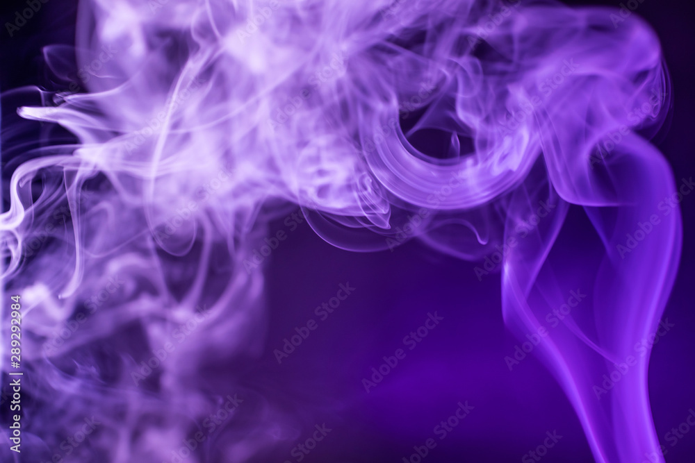 Smoke on a dark background in a bright trendy purple neon light. Minimalistic background concept. Smoke on a dark background in a bright trendy purple neon light. Minimalistic background concept.