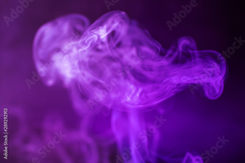 Smoke on a dark background in a bright trendy purple neon light. Minimalistic background concept.