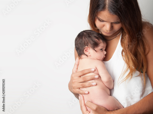 Obraz na płótnie Australian mother holding newborn baby girl on white background