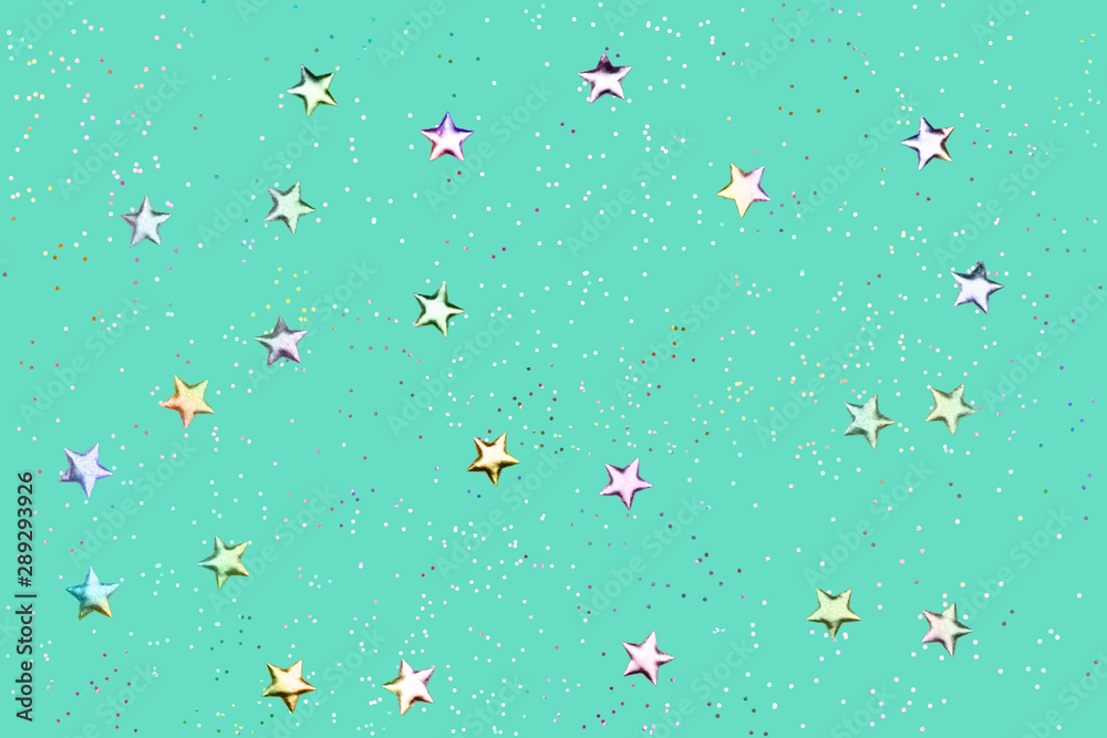 Green mint background with holographic glitter and metallic stars. Flat lay style