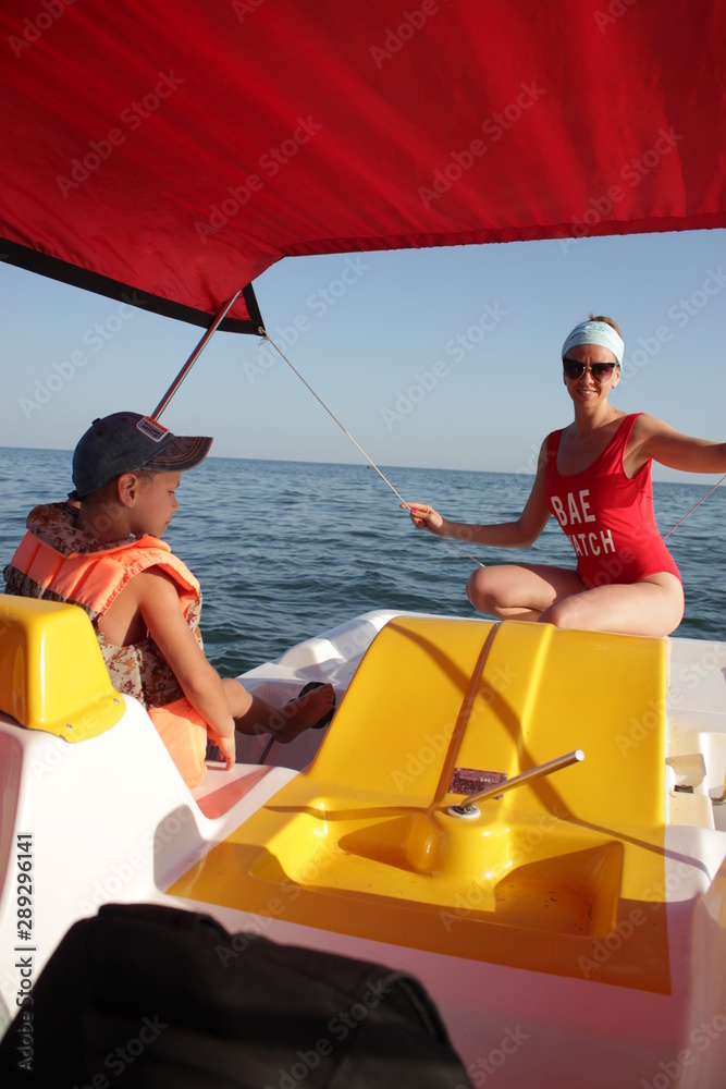 family rides on the Black Sea in a pleasure boat