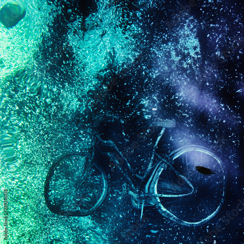 Environmental background with bicycle into the sea water. 