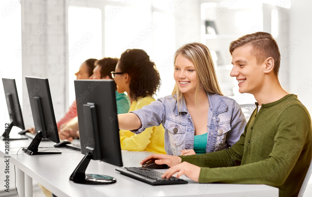 education, technology and learning concept - group of happy international high school students or classmates in computer class education, technology and learning concept - group of happy international high school students or classmates in computer class