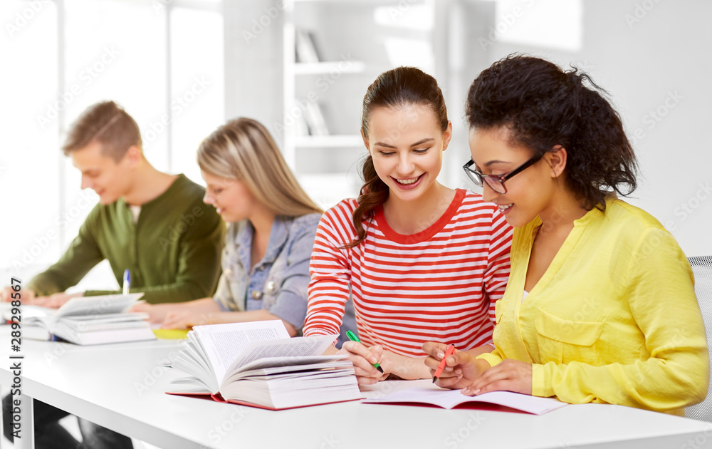 education, learning and people concept - happy high school student girls or classmates with books and notebooks education, learning and people concept - happy high school student girls or classmates with books and notebooks
