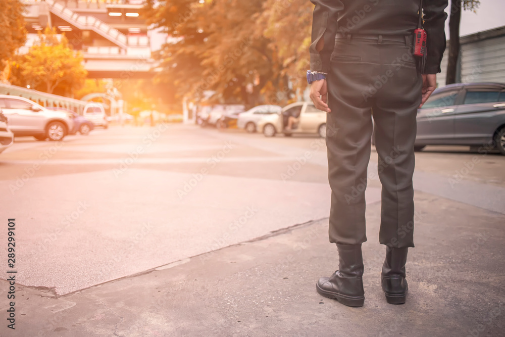 Security guard uses radio communication for facilitate traffic. Traffic Officers use walkie talkie to maintain order in the parking lot in Thailand. Security guard uses radio communication for facilitate traffic. Traffic Officers use walkie talkie to maintain order in the parking lot in Thailand.