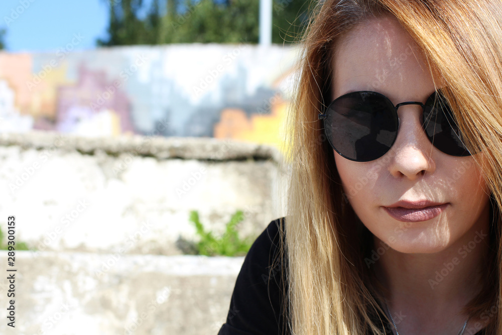 Portrait of a young girl in sunglasses, stylish street atmosphere. Portrait of a young girl in sunglasses, stylish street atmosphere.