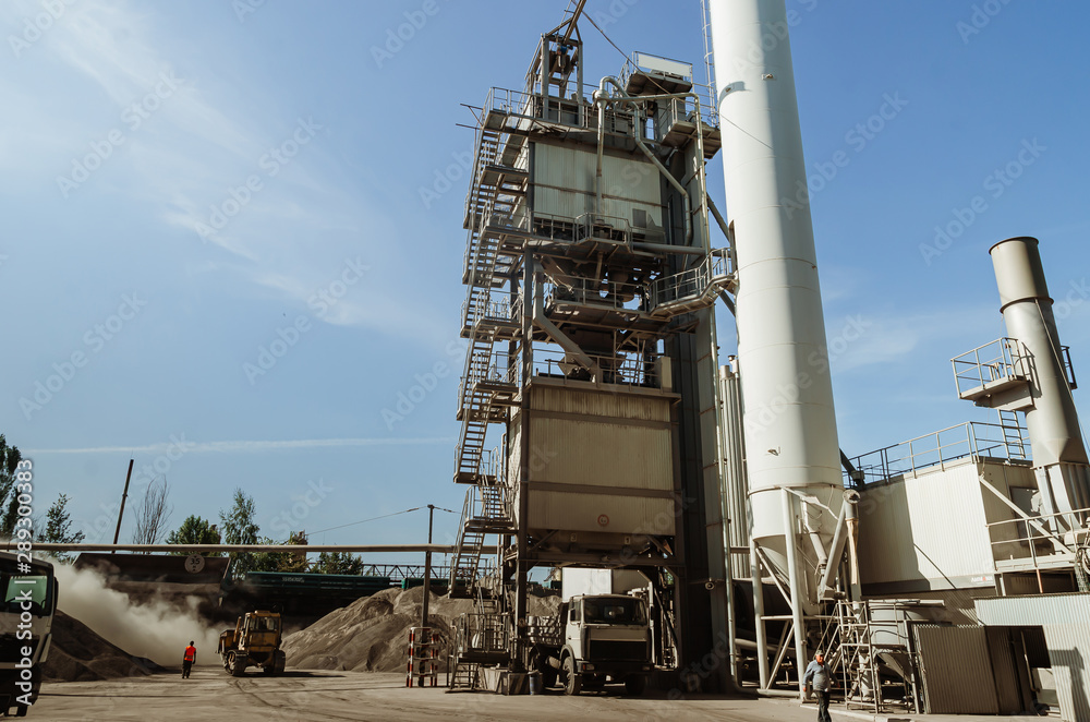 Equipment for production of asphalt, cement and concrete. Concrete plant. High tower of an asphalt plant. Harmful production. A mixture of bitumen and gravel, a mix machine.