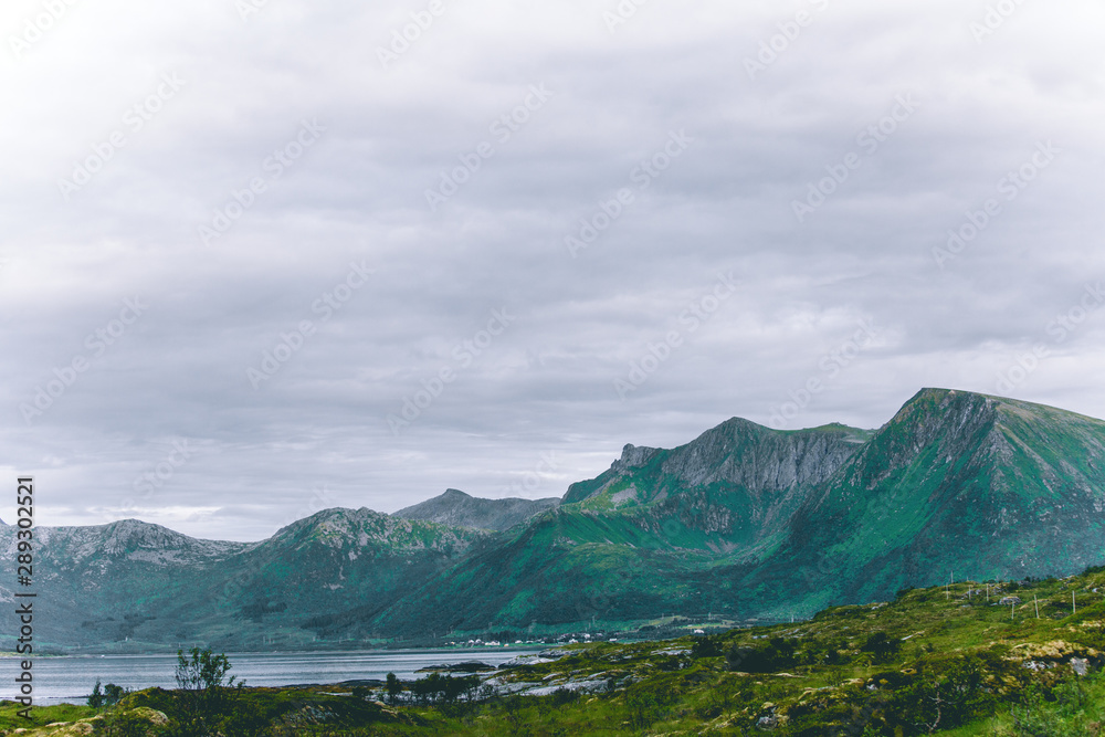 Photo of sea, hills, cloudy sky at Norway.