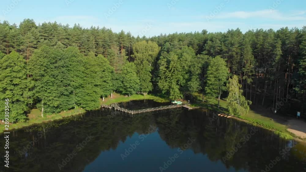 Aerial flying around a wooden pier and boardwalk on the edge of Saulys lake in the sunshine of a Lithuanian summer Aerial flying around a wooden pier and boardwalk on the edge of Saulys lake in the sunshine of a Lithuanian summer