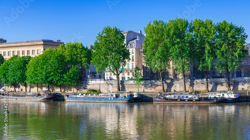 Paris, beautiful houses on the quay, with a view of the Seine, typical facades and houseboats