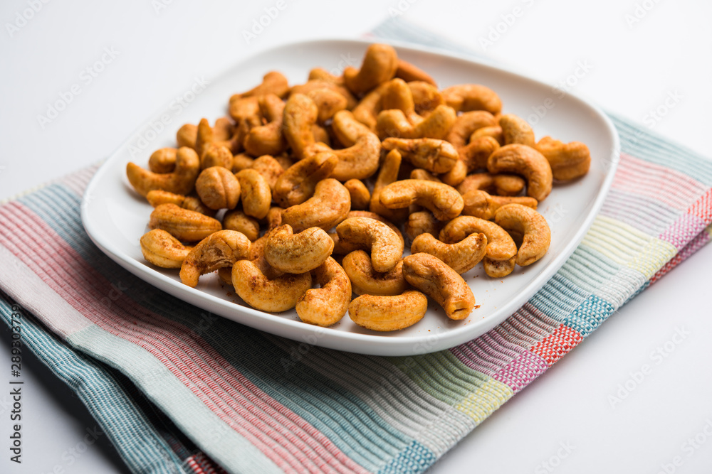 Masala Kaju or spicy Cashew in a bowl. Popular festival snack from India/asia, also known as Chakna recipe Masala Kaju or spicy Cashew in a bowl. Popular festival snack from India/asia, also known as Chakna recipe