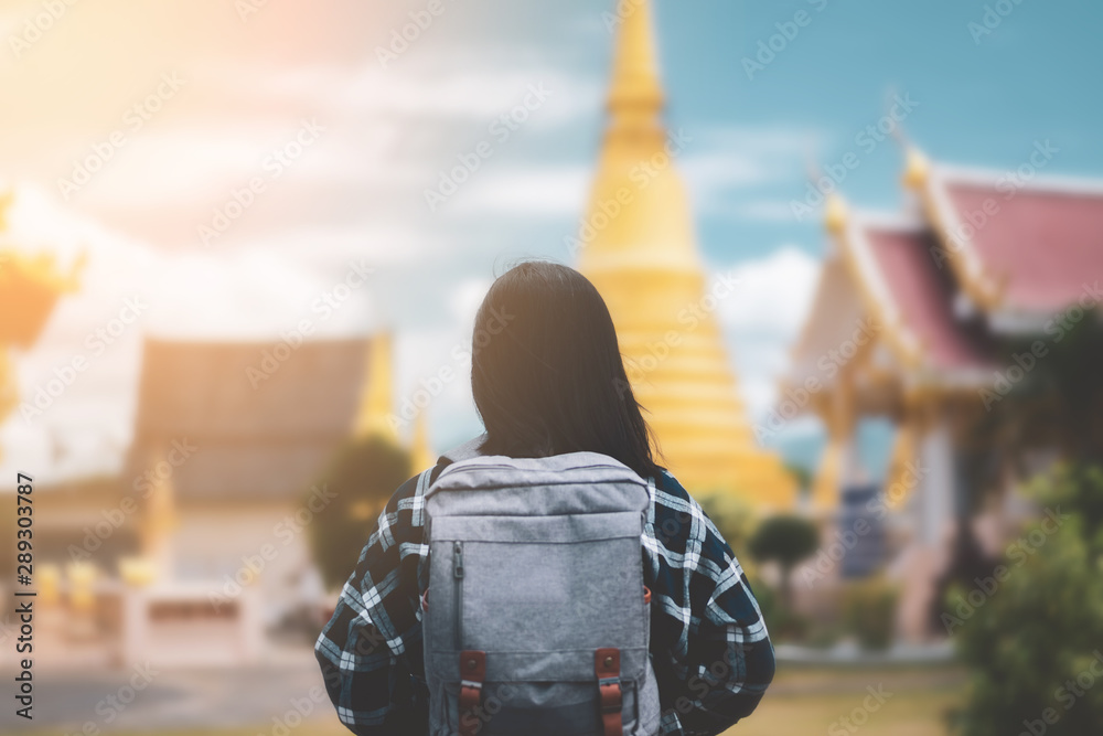 Backpack woman standing front of blur temple Thailand with blue sky and  white cloud background. Stock Photo | Adobe Stock