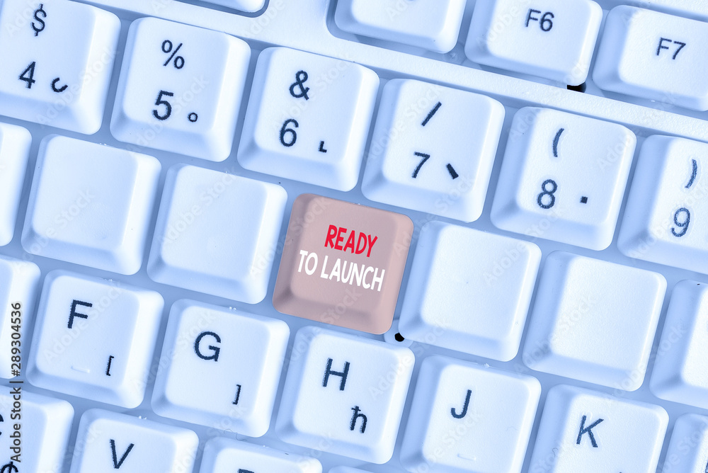Writing note showing Ready To Launch. Business concept for an event to celebrate or introduce something new to market White pc keyboard with note paper above the white background Writing note showing Ready To Launch. Business concept for an event to celebrate or introduce something new to market White pc keyboard with note paper above the white background
