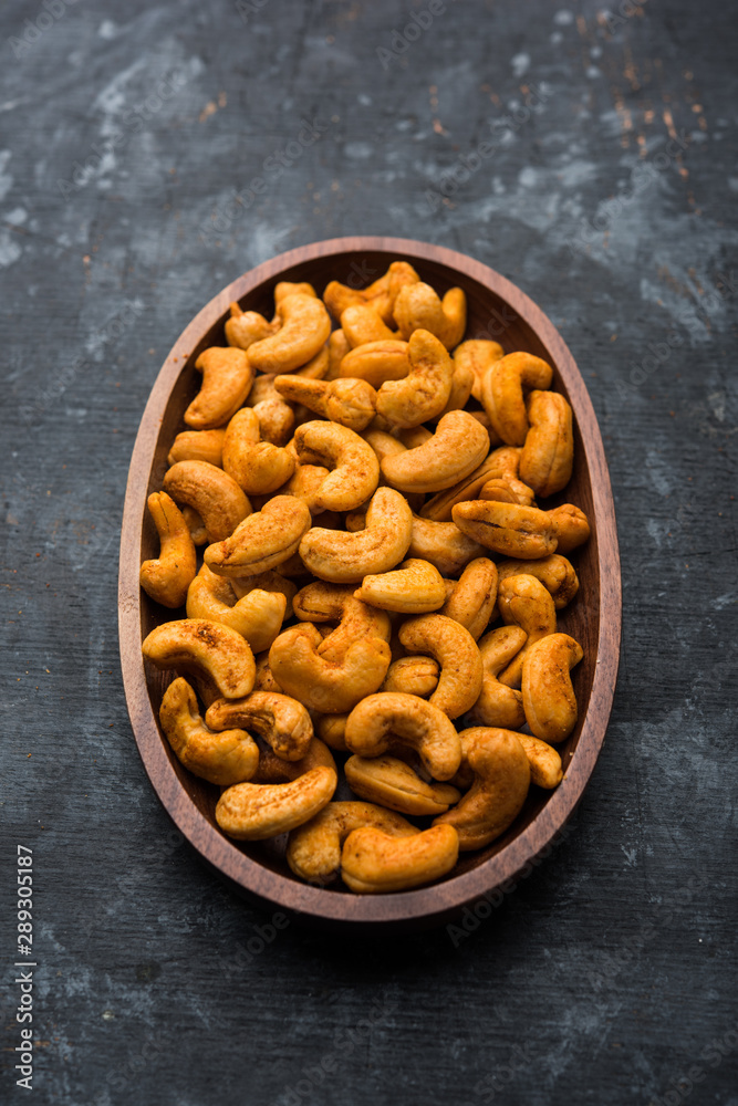 Masala Kaju or spicy Cashew in a bowl. Popular festival snack from India/asia, also known as Chakna recipe Masala Kaju or spicy Cashew in a bowl. Popular festival snack from India/asia, also known as Chakna recipe