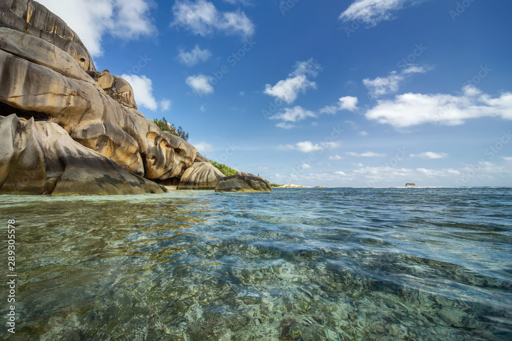 Turquoise water at high tide and bizarre rocks on the island of La Digue, Seychelles