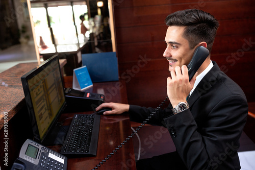 Elegantly dressed receptionist holding a headphone photo