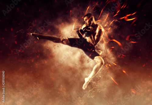 Canvas Print MMA male fighter kick. Flames background