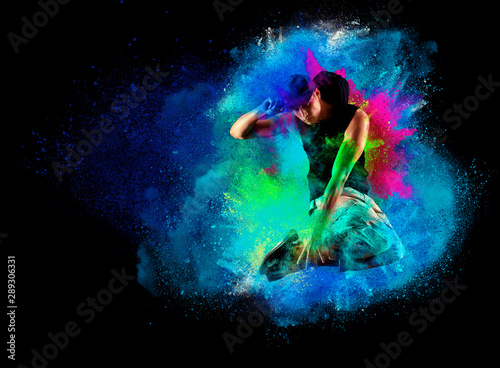 Fototapeta Naklejka Na Ścianę i Meble -  Dancer jumping in hoodie with colourful splashes