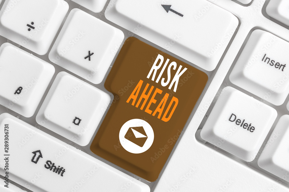 Conceptual hand writing showing Risk Ahead. Concept meaning A probability or threat of damage, injury, liability, loss White pc keyboard with note paper above the white background Conceptual hand writing showing Risk Ahead. Concept meaning A probability or threat of damage, injury, liability, loss White pc keyboard with note paper above the white background