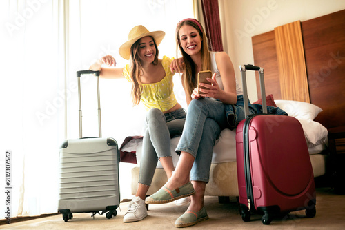 Two pretty girls in their hotel room photo