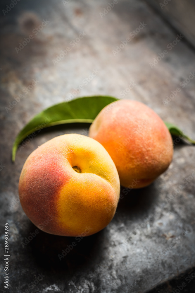 Sweet ripe peaches on the rustic background. Selective focus. Shallow depth of field. Sweet ripe peaches on the rustic background. Selective focus. Shallow depth of field.