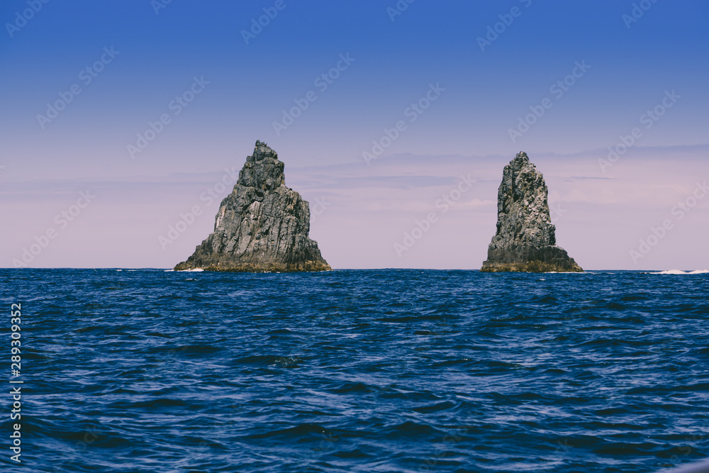 The Friars—four steep dolerite rock islands off the coast of Bruny Island in Tasmania, Australia