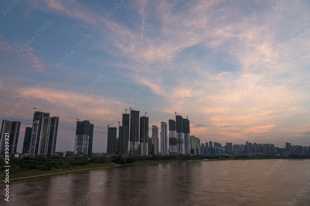 Skyline Landscape of River and Riverbank Architecture in Asian Cities at Dusk
