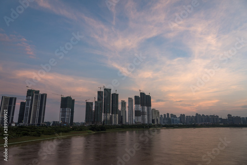 Skyline Landscape of River and Riverbank Architecture in Asian Cities at Dusk © bqmeng