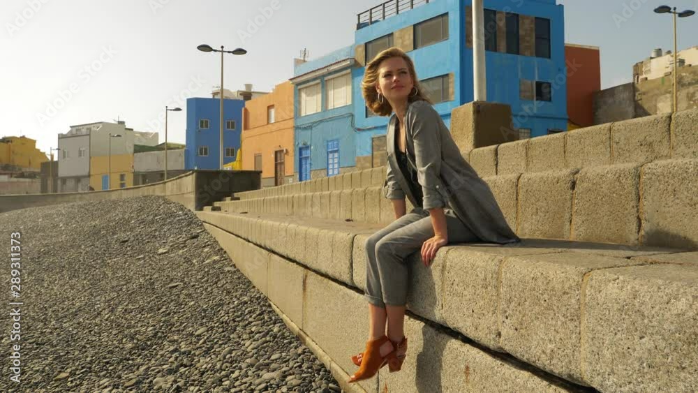 Gorgeous Model in Blazer Sitting by the Concrete Stairs Gorgeous Model in Blazer Sitting by the Concrete Stairs