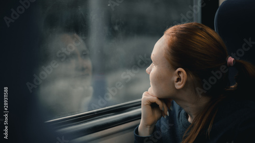 Girl looks out the train window