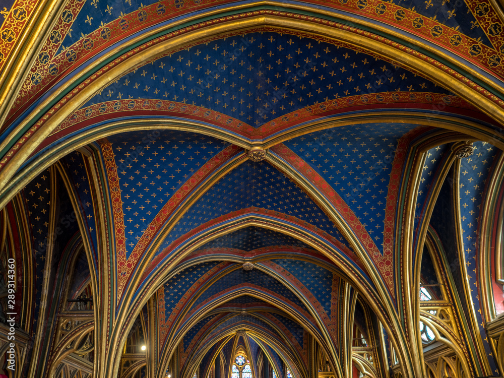 PARIS - May 2018: The Sainte Chapelle in Paris, France. This 1246 inspired monument features 15 wonderful stain-glass windows in Paris. PARIS - May 2018: The Sainte Chapelle in Paris, France. This 1246 inspired monument features 15 wonderful stain-glass windows in Paris.