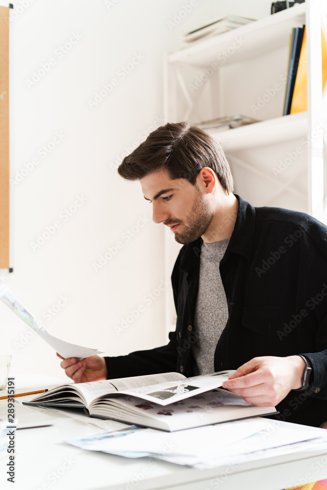 Professional man architect in office reading book work with paper. Professional man architect in office reading book work with paper.