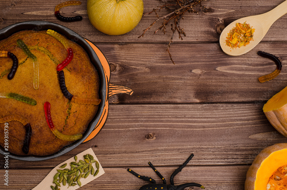 Halloween background with copy space pumpkin pie with orange pumpkins