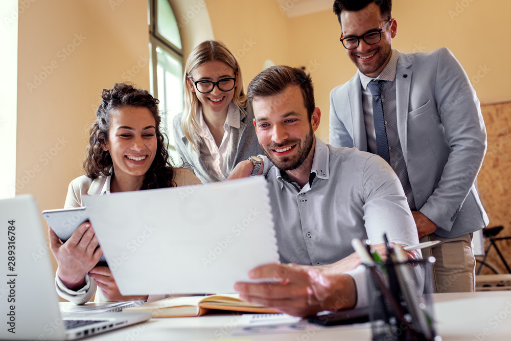 Group of young business people working together while sitting at the office desk. Group of young business people working together while sitting at the office desk.
