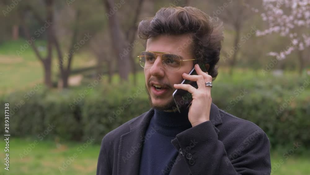 stressed young business man have a work phone call in the park stressed young business man have a work phone call in the park