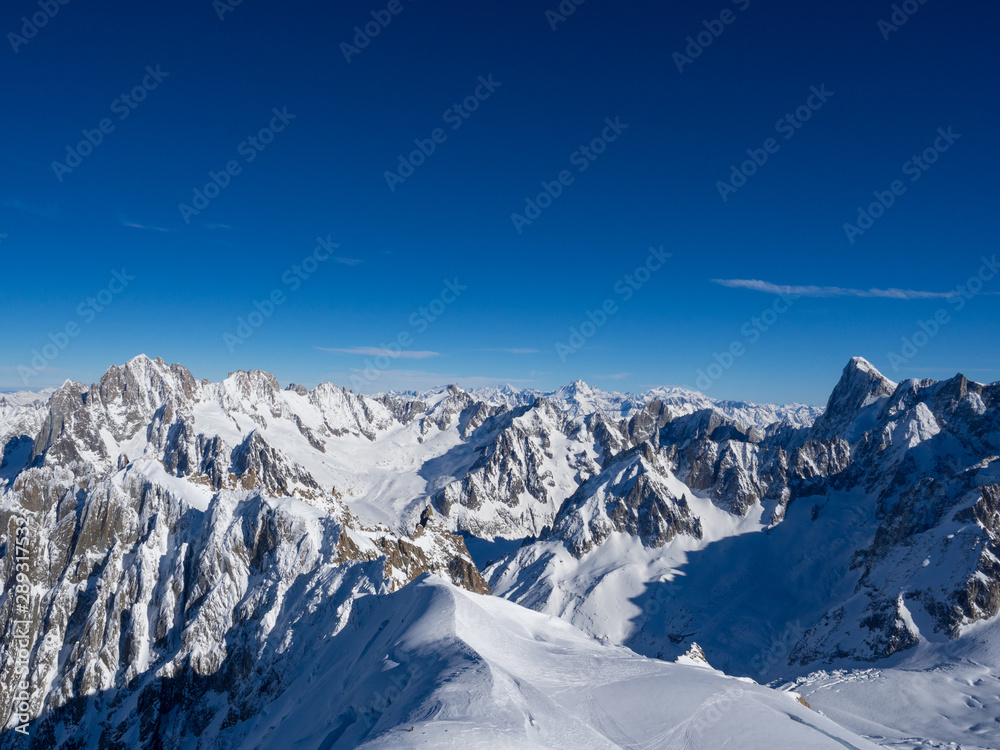 Obraz premium France, january 2018: View on Chamonix Valley from top of Aiguille du Midi summit on a sunny winter day