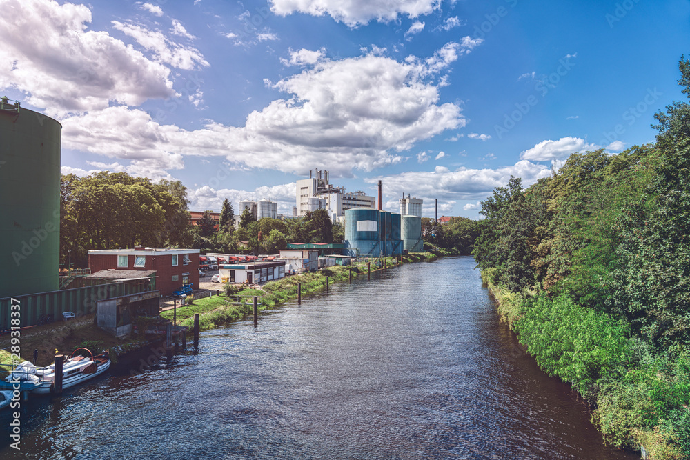 Berlin canal in summer with industrial plants
